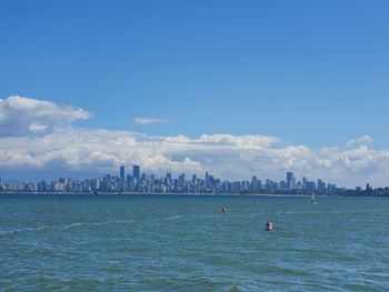 Scenic view of sea and buildings against sky