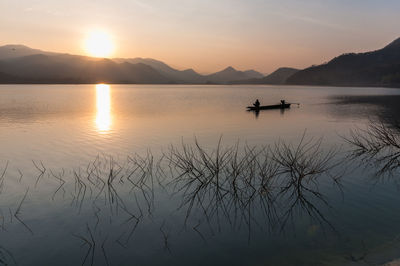 Scenic view of lake against sky during sunset