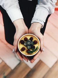 Midsection of man holding fruit