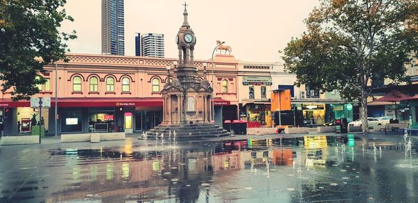 Reflection of buildings on wet street in rainy season