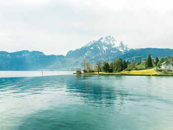 Scenic view of lake and mountains against sky