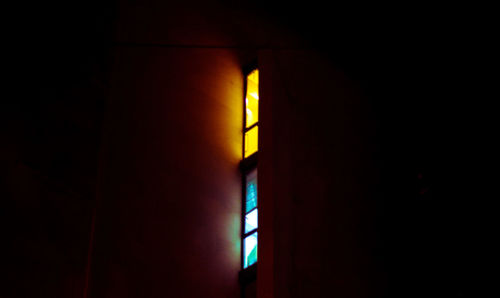 Close-up of illuminated lamp in dark room