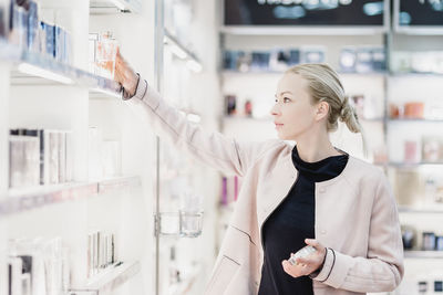 Portrait of young businesswoman standing in factory