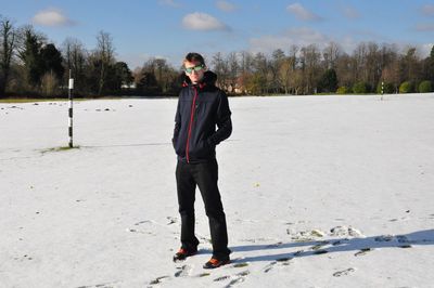 Full length portrait of man standing on snow covered land