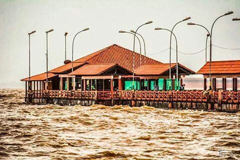 built structure, architecture, building exterior, water, beach, sea, sand, clear sky, waterfront, in a row, flag, sky, house, day, outdoors, shore, beach hut, pier, multi colored, nature