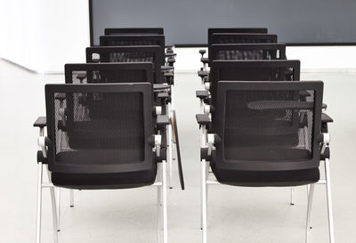 Close-up of empty chairs in classroom