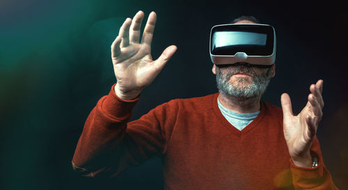 Midsection of man using vr glasses