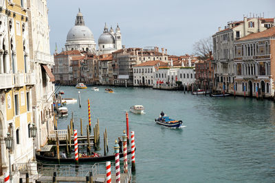 Boats in canal against sky