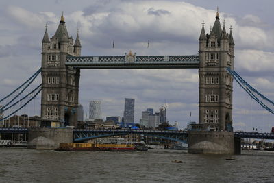 View of bridge over river against cloudy sky