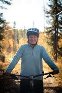 Lady with a lovely smile while recreationally sporting. cyclist riding fat bike in finnish nature. 