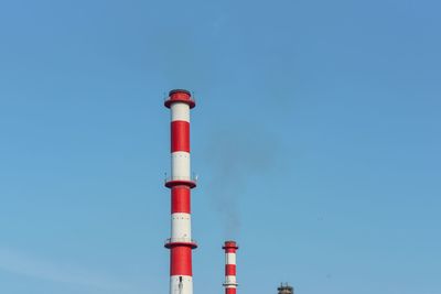 Low angle view of lighthouse against clear blue sky