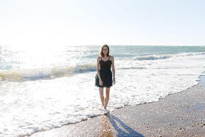 Young girl in dress enjoying a vacation near the summer sea of italy