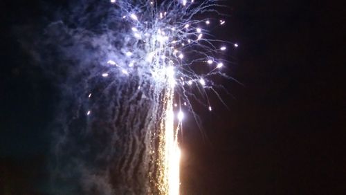 Low angle view of firework display against sky at night