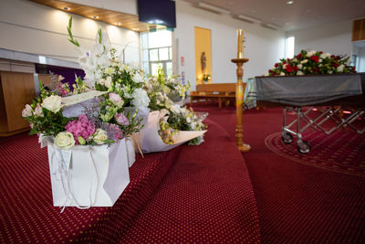 Closeup shot of a funeral casket or coffin in a hearse or chapel or burial at cemetery
