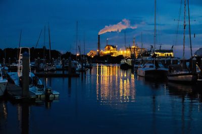 Boats moored in harbor at night