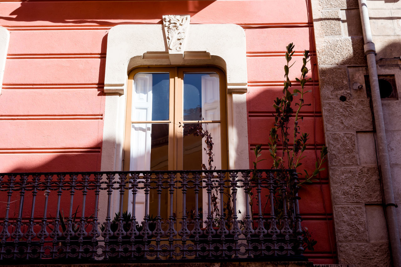 LOW ANGLE VIEW OF BUILDING SEEN THROUGH WINDOW