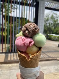 Close-up of hand holding ice cream cone