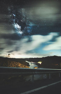 Scenic view of star field over landscape at night