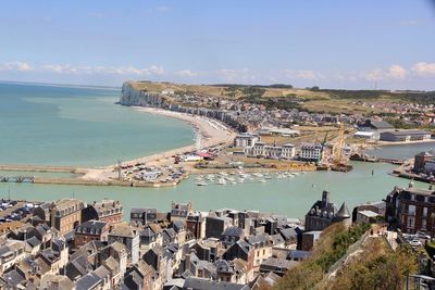 High angle view of townscape by sea against sky