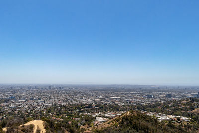 High angle view of townscape against clear blue sky