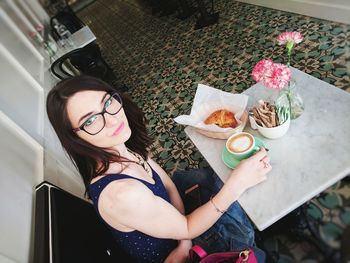 Portrait of young woman having coffee at cafe