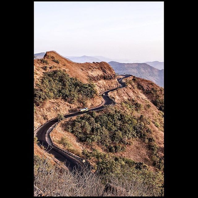 mountain, transfer print, landscape, tranquility, tranquil scene, clear sky, auto post production filter, mountain range, scenics, transportation, nature, beauty in nature, non-urban scene, sky, remote, day, physical geography, copy space, high angle view, no people