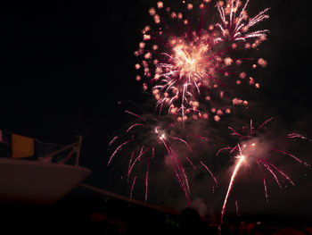 Low angle view of firework display at night