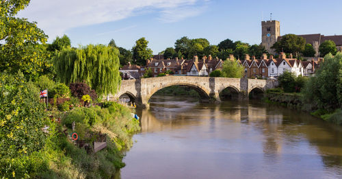 Arch bridge over river against sky