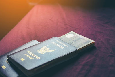 Close-up of currency with passport on table