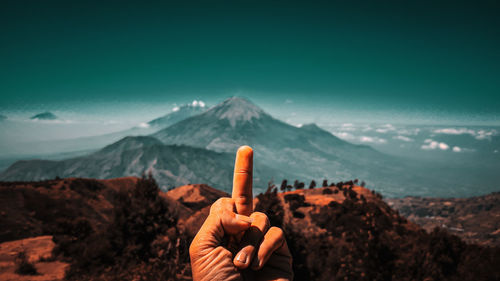 Person on mountain against sky