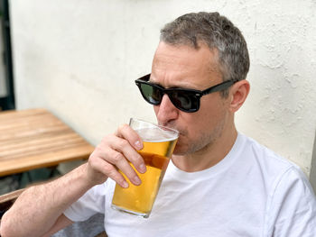 Middle aged man drinking beer in cafe or restaurant pub outdoor.drinking alcohol lager or ale.candid