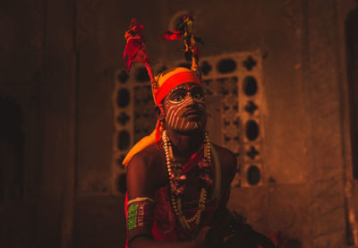 Midsection of man wearing mask against wall