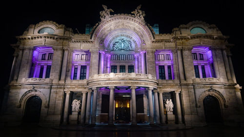 Low angle view of illuminated building at night