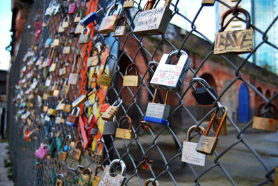 Padlocks hanging on railing