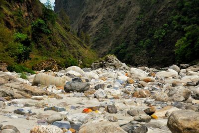 Rocks on land against mountains