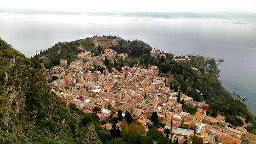 High angle view of houses and sea against sky