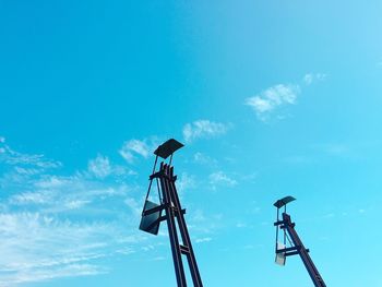 Low angle view of crane against blue sky