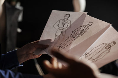 Cropped hand of woman holding paper