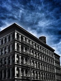 Low angle view of building against cloudy sky