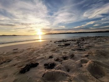 Scenic view of beach against sky during sunset