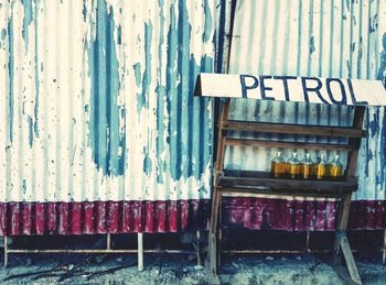 Petrol in bottles against corrugated iron