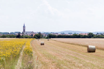 Rural landscape against cloudy sky