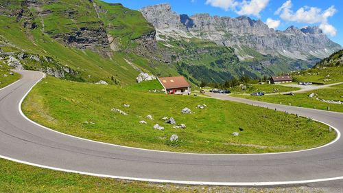 Scenic view of grassy field against mountains