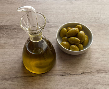 Extra virgin olive oil isolated on wooden background