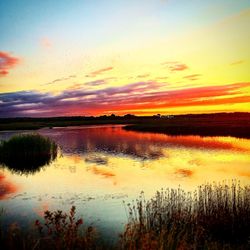 Scenic view of lake at sunset