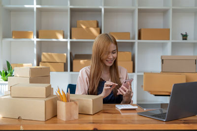 Midsection of woman using laptop on table