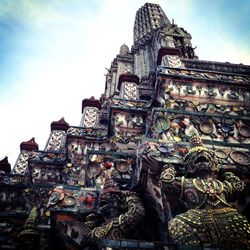 Low angle view of sculptures on temple against sky