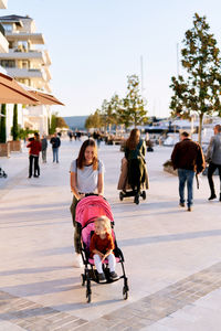 Rear view of people walking on street