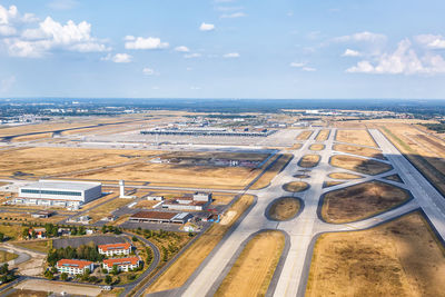 Aerial view of city by sea against sky