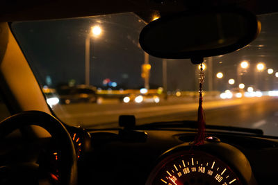 Illuminated lights seen through car windshield at night